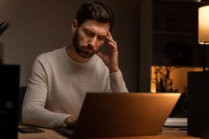 man working late night in tension